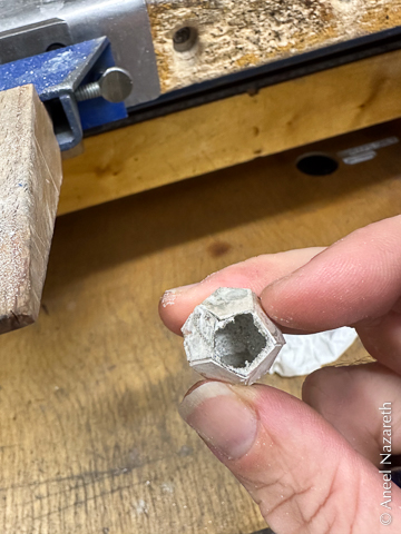 A mostly complete dodecahedron, with one face roughly ground out